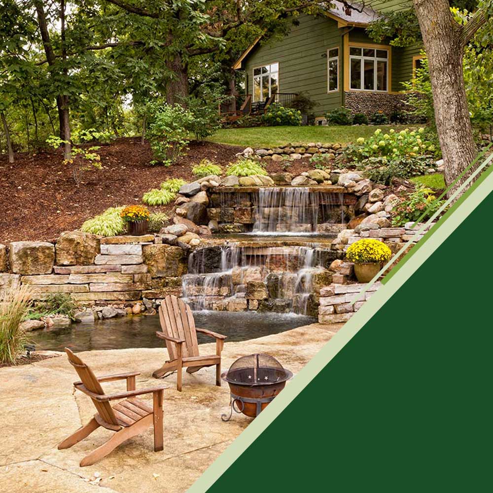Chairs and fire pit area with waterfall and home in the background